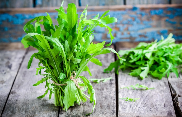 arugula bunch on a wood floor