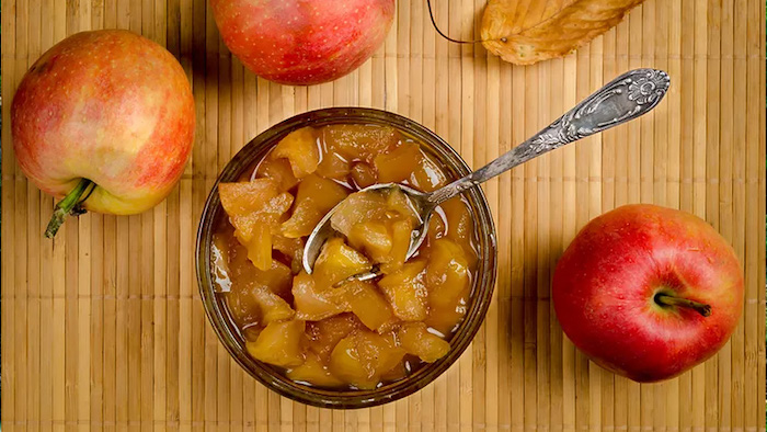 apple pectin in a bowl surrounded by apples