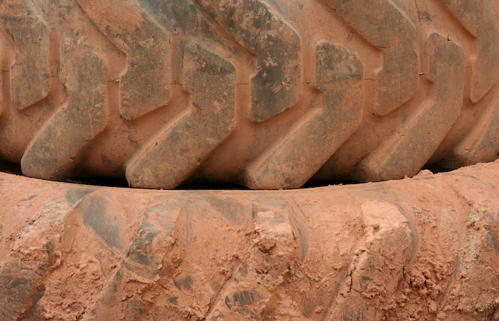 dusty tires stacked up outside