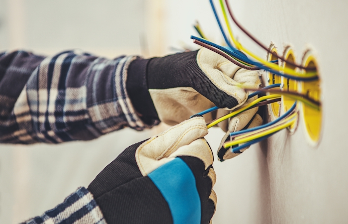 person with gloves adjusting wires