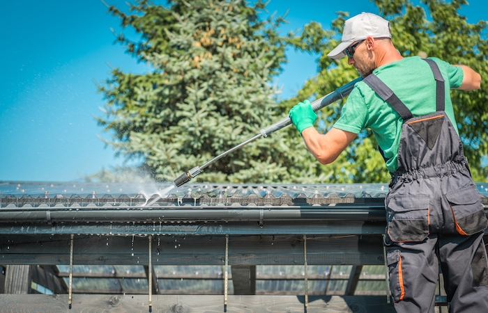 farmer washing a roof