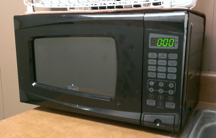old microwave on a countertop