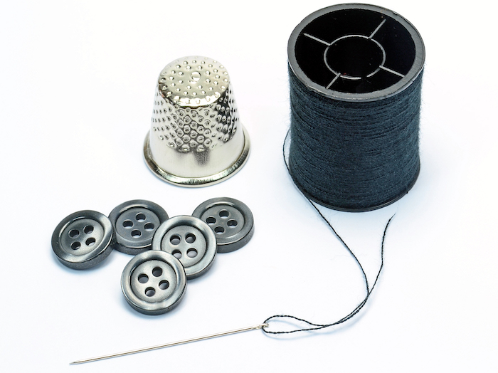 A sewing needle, sewing thread, and buttons