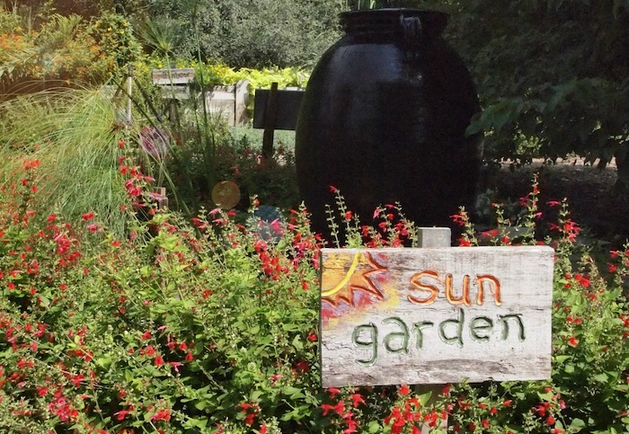 garden with a sign that says sun garden