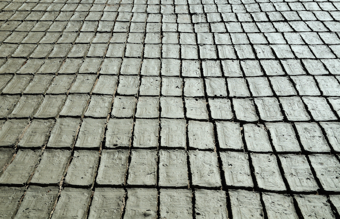 Long row of grey mud bricks