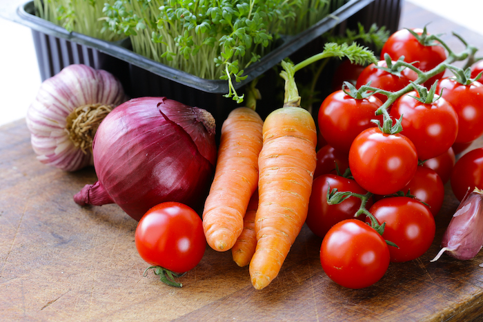 fresh garden vegetables laid out on a table