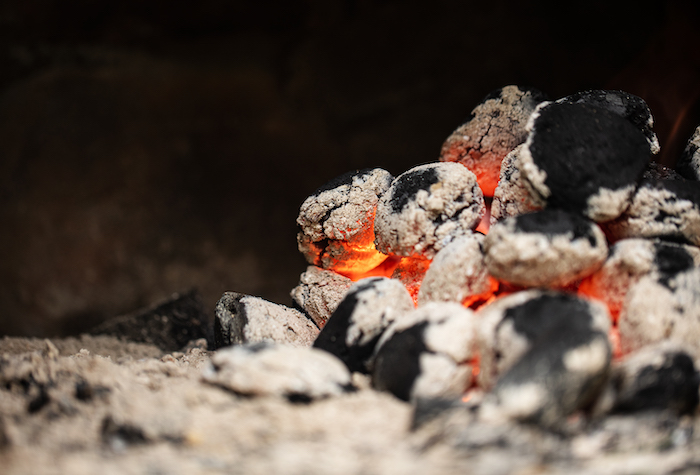 Charcoal burning in a pile.