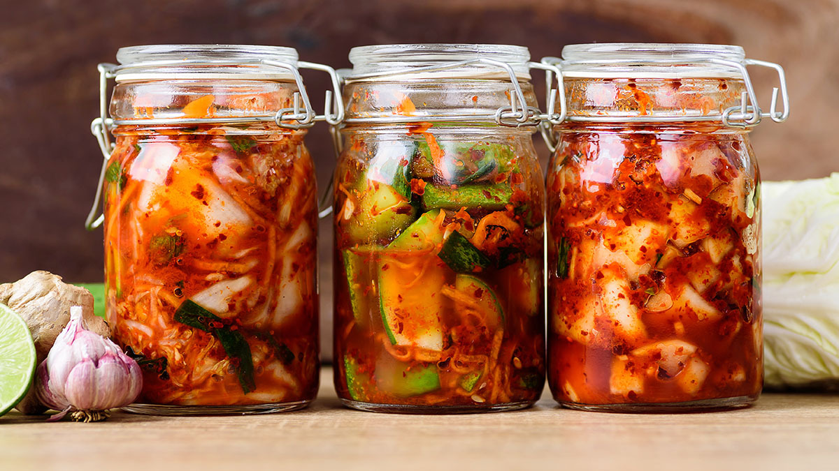 Jars of fermented food sitting on a counter.