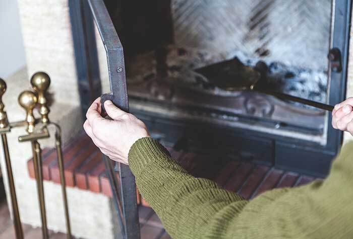 A person cleaning out their chimney in preparation for winter.