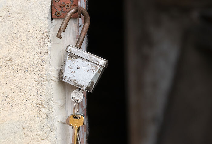 Keys sitting in a lock on a barn door.