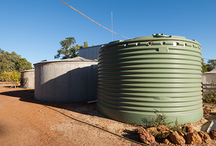 Large water storage tanks standing on a farm.